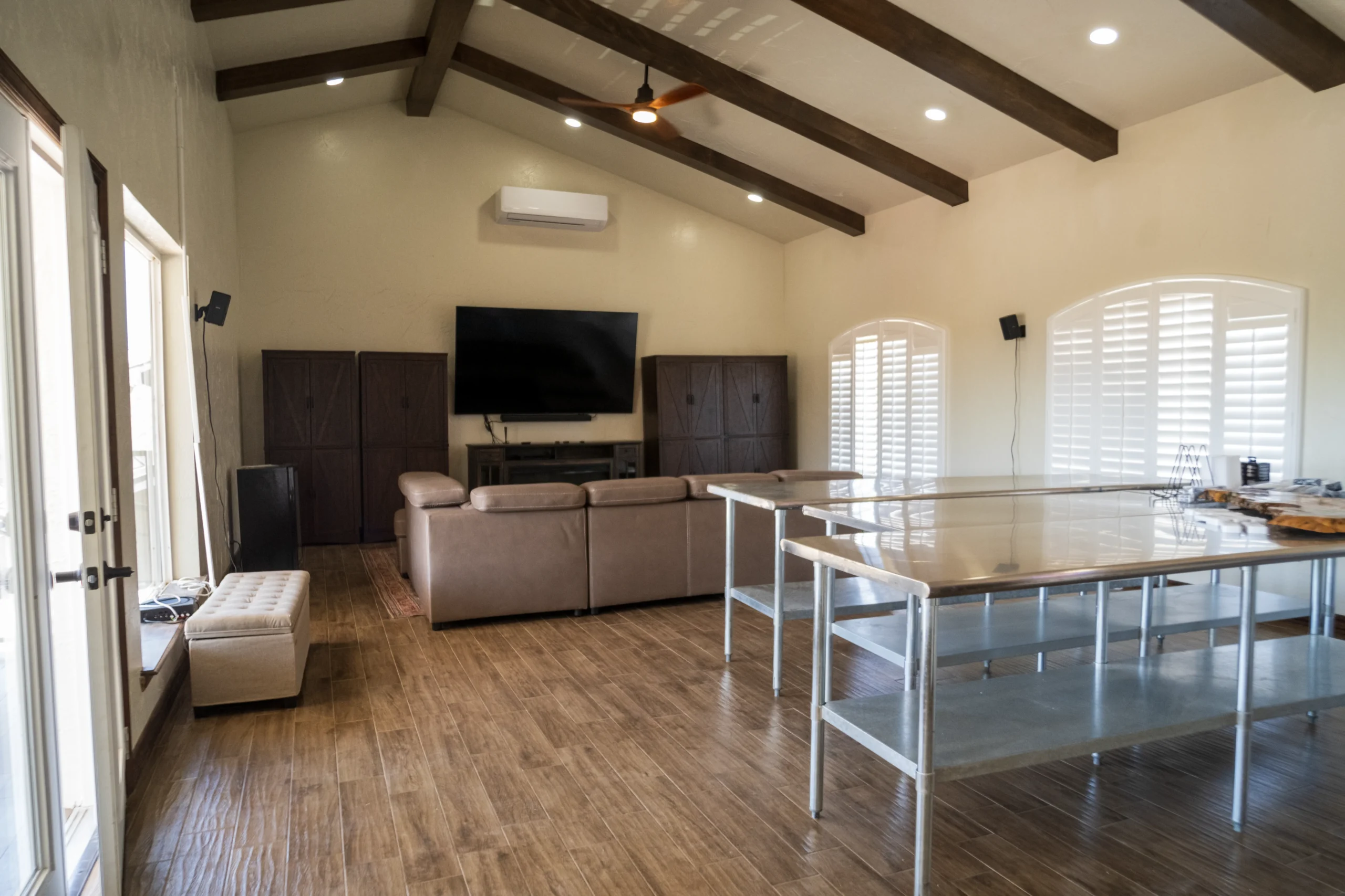 Living room with wood flooring and vaulted beam ceiling installed in an El Paso, TX home